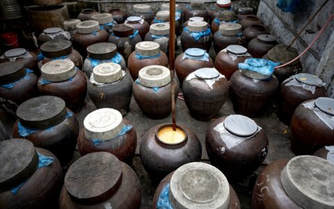 A collection of rustic ceramic jars in a traditional storage setting, showcasing cultural heritage.