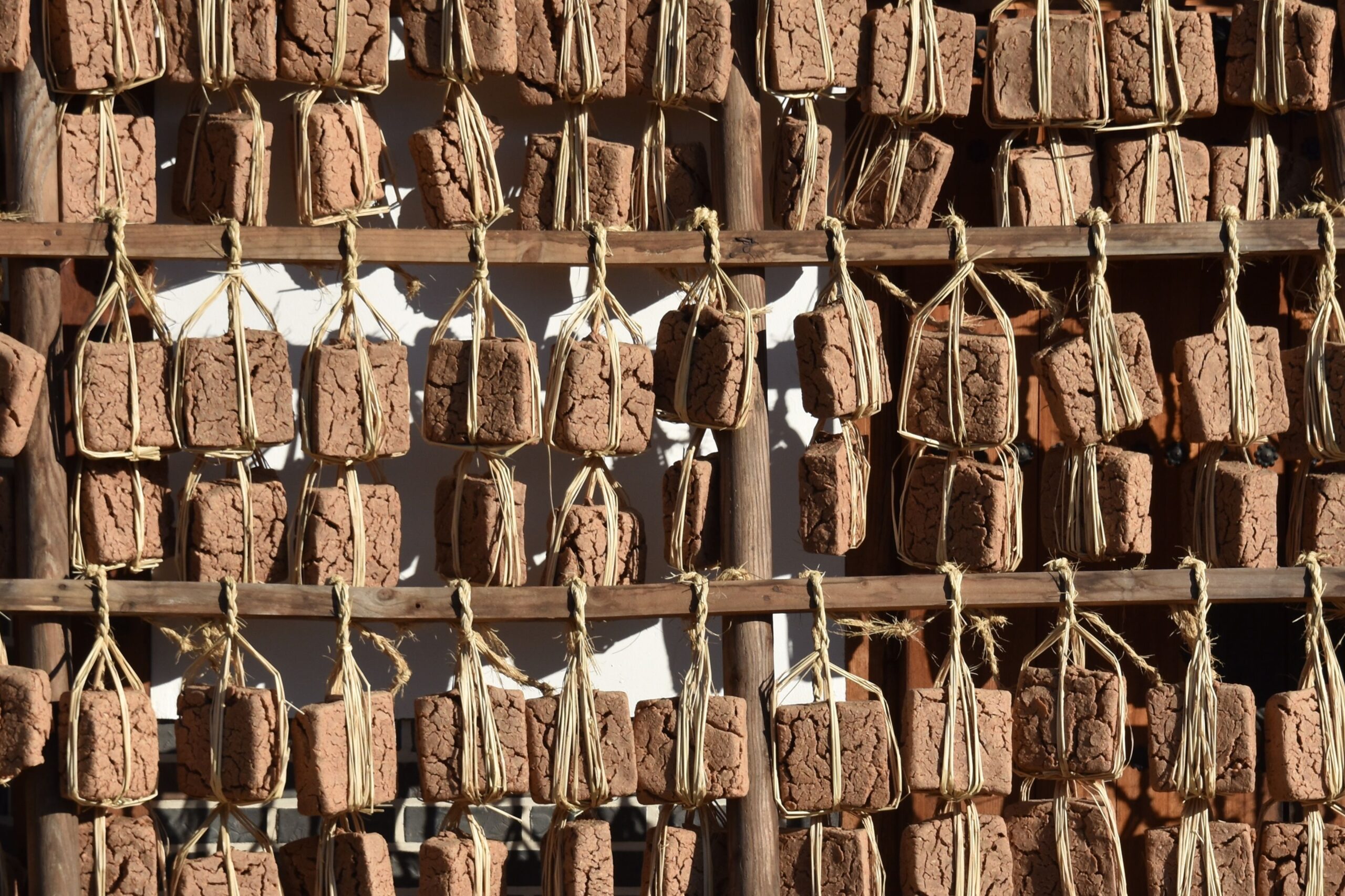 Authentic Korean meju blocks hanging outdoors for fermentation, essential in Korean cuisine.